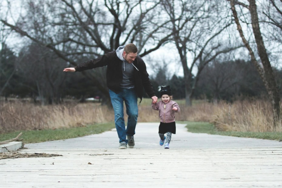 A Father And His Little Girl Running On A Park Pathway By Josh Willink